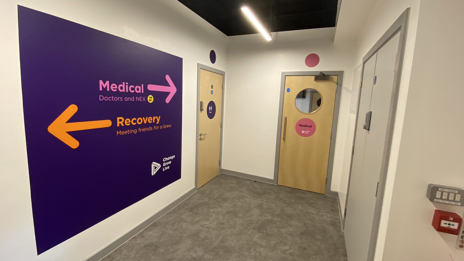 A hallway in the Wirral hub with signposts to different places in the service