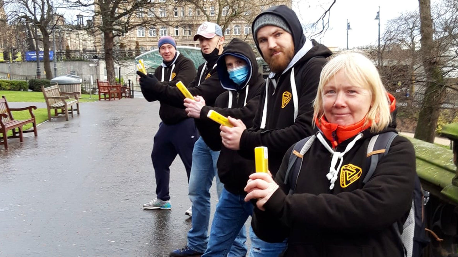 A team of people holding naloxone