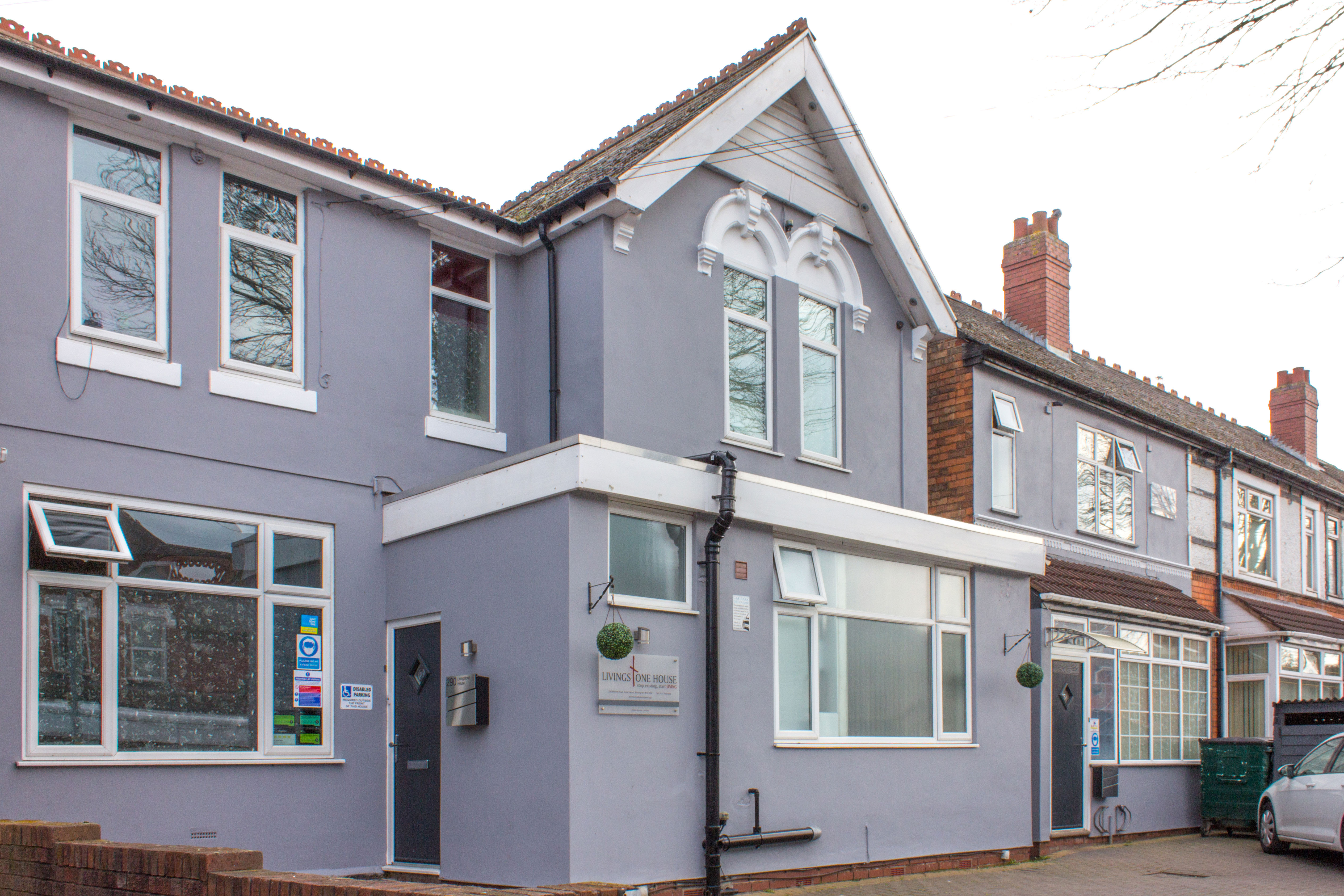 The outside of a two-story building that is painted grey