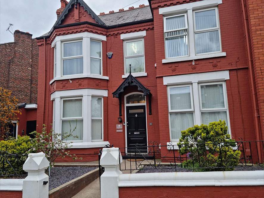 The front of the building - a red-bricked Edwardian building with a black front door and large sash windows