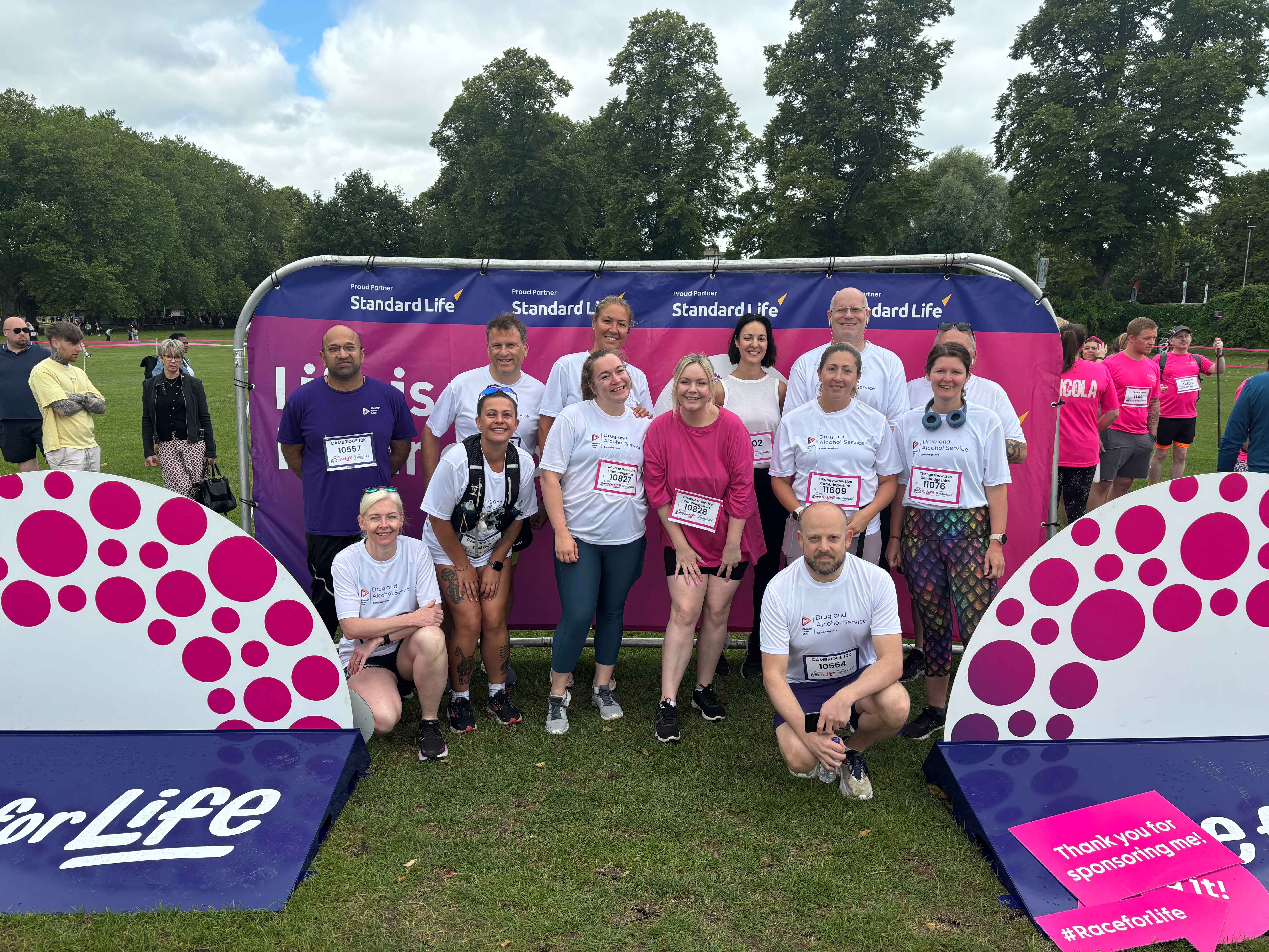 A group of people stood in front of Race for Life banners