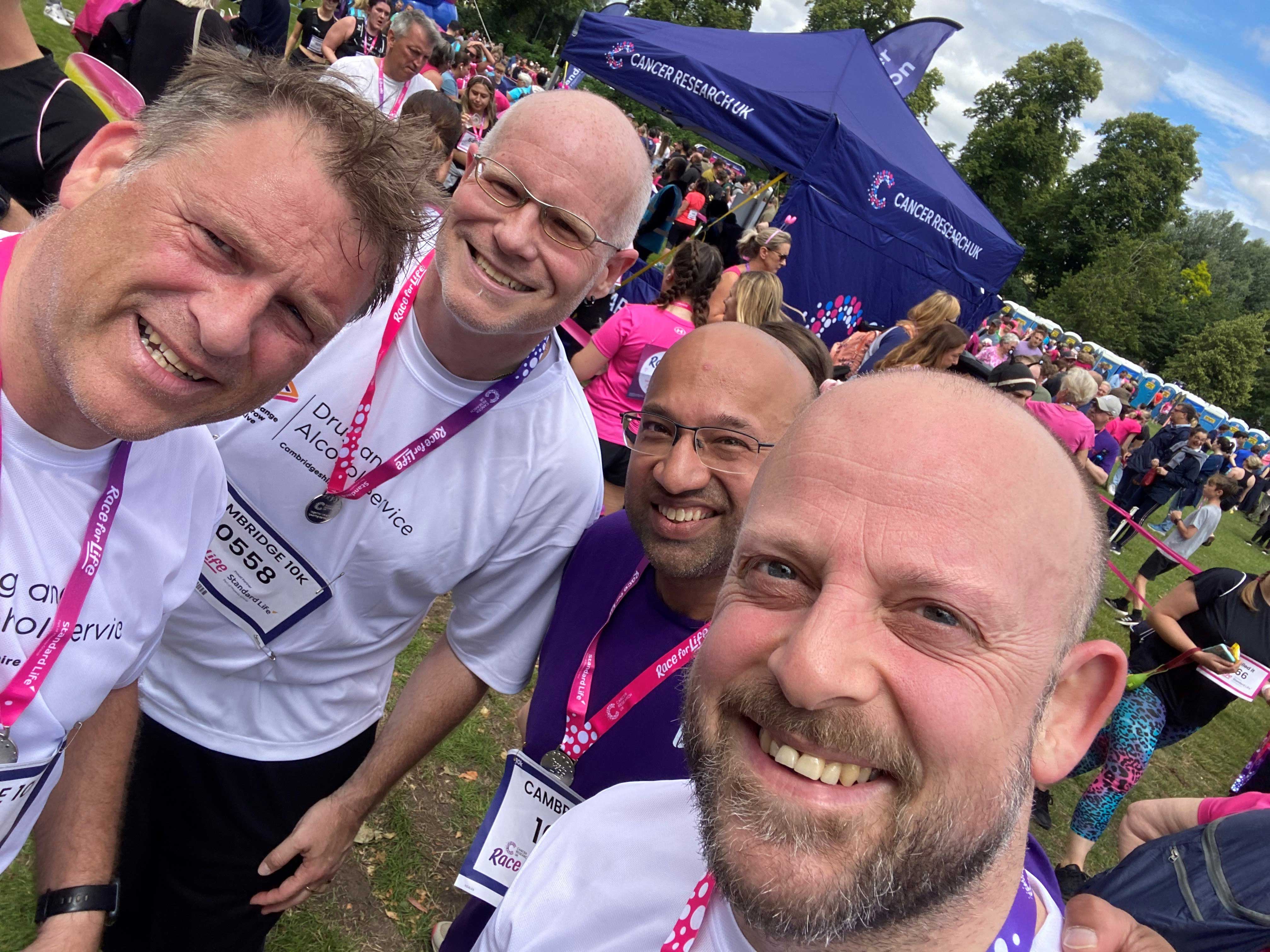 Three people taking a selfie with medals round their necks from Race for life