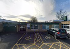 A small building with two disabled parking spaces out the front