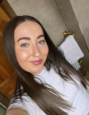 Chloe has long brown hair and is taking a selfie