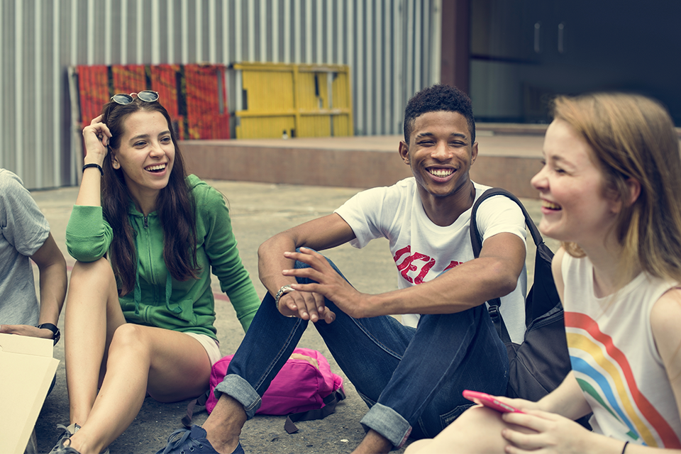 A group of young people smiling and laughing