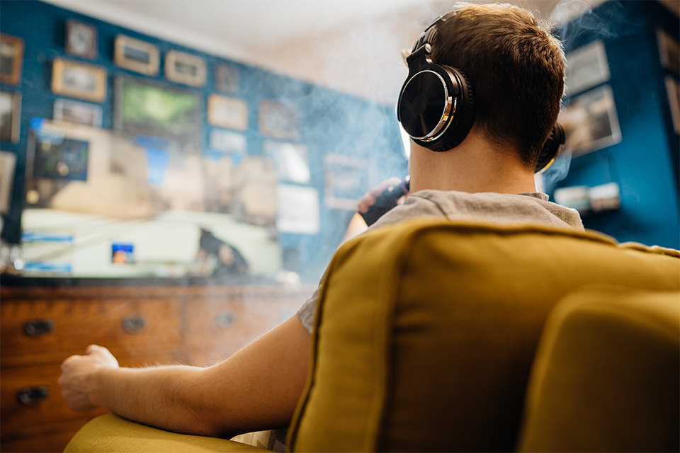 A person facing away from the camera smoking a vape