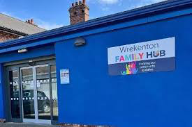 A blue building with a sign for the Wrekenton family hub