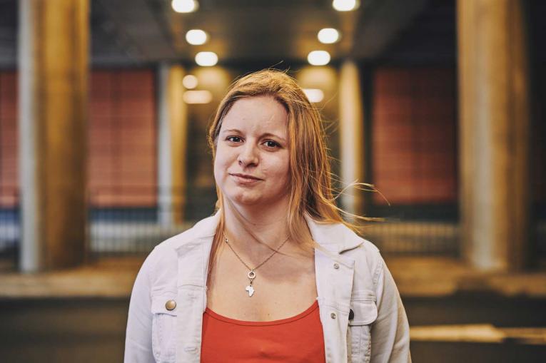 woman smiling under a bridge