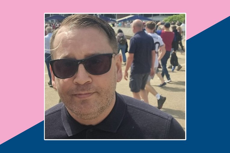 Man with short brown hair wearing a black polo shirt and sunglasses
