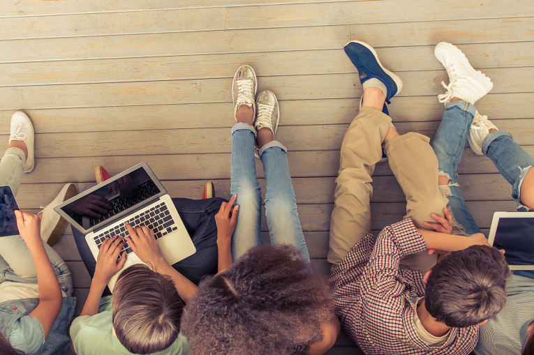 A top down photo showing a group of young people sat together