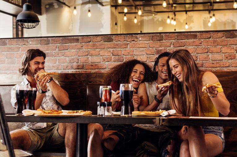 A group of friends eating together in a restaurant