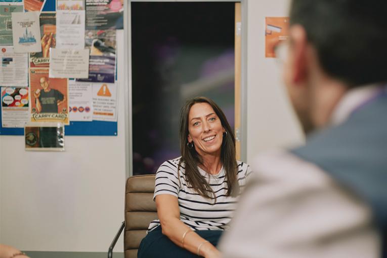 Two people in conversation with one slightly out of focusople