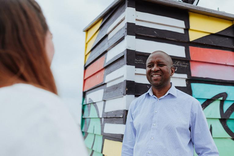 Two people in conversation with one slightly out of focus