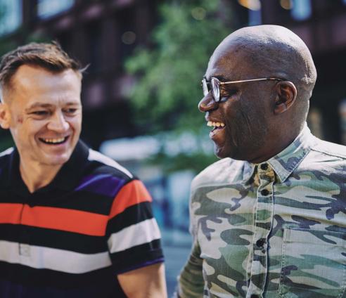 two men talking and smiling