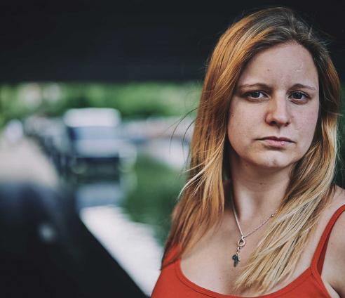 A woman standing in front of a canal