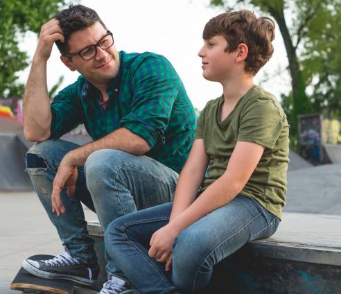 A man and a child at a skatepark
