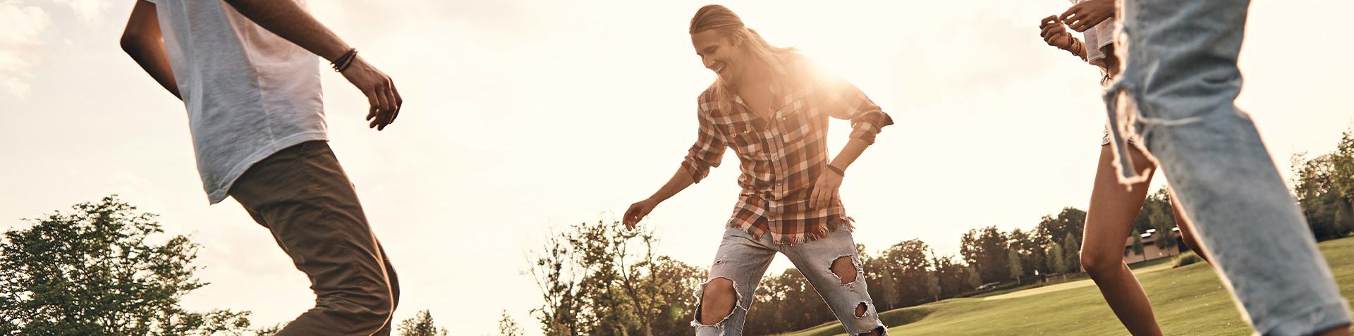 A group of people playing football in a field