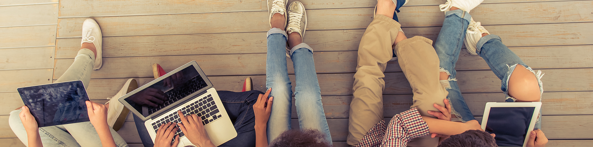 A top down photo showing a group of young people sat together