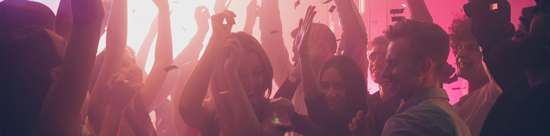 A crowd of people partying at a night club