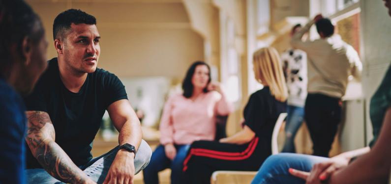 A group of people are sitting having a conversation