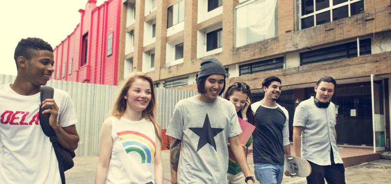 Large group of young people walking and laughing