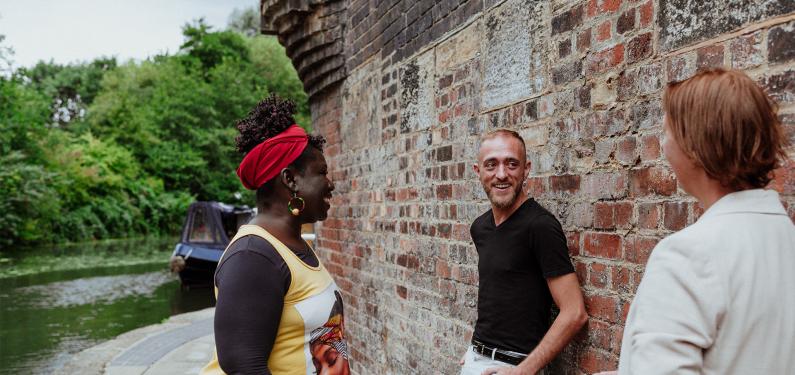 A group of people talking outside