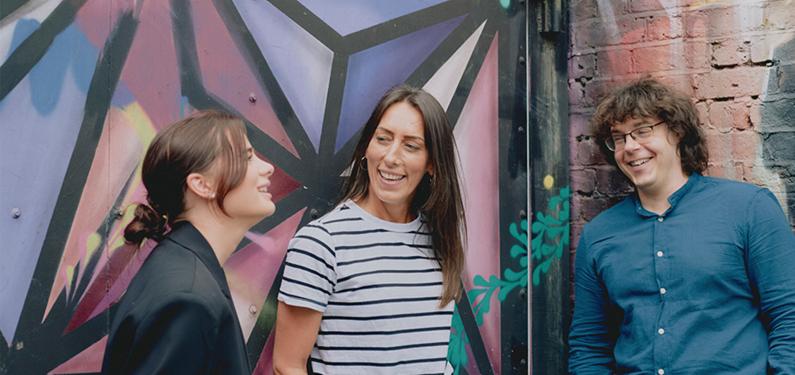 A group of people talking outside