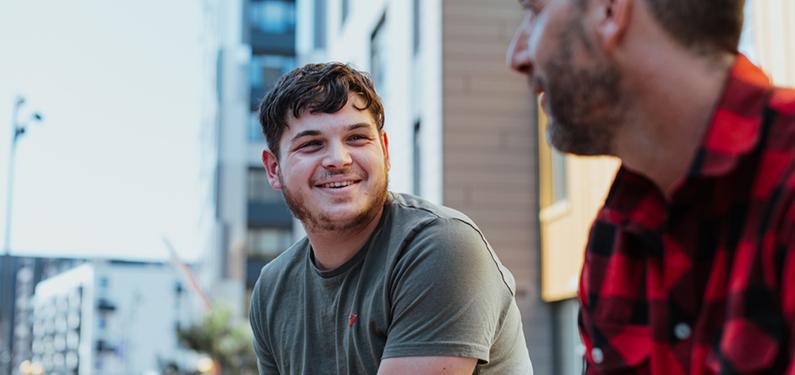 Two people in conversation with one slightly out of focus