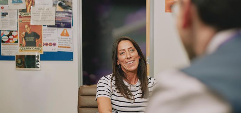 Two people in conversation with one slightly out of focusople